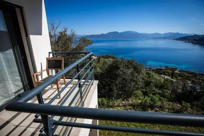 a balcony with a view of the water at Villa d'architecte classée 5 étoiles in Campomoro
