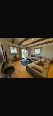 a large living room with a couch and a table at Loue Villa Bonifacio vue mer in Bonifacio