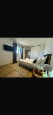 a bedroom with a large bed and a window at Loue Villa Bonifacio vue mer in Bonifacio