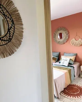 a bedroom with a bed and mirrors on the wall at Casa Lucia in Aléria