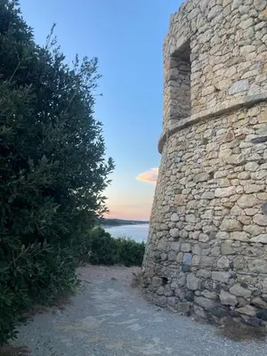 a stone wall with a view of the water at Casa Lucia in Aléria