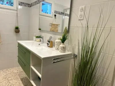 a bathroom with a sink and a mirror at Casa Lucia in Aléria