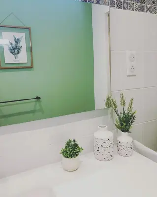 three plants in white vases sitting on a bathroom sink at Casa Lucia in Aléria