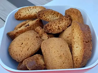 a blue bowl filled with muffins sitting on a table at Chez Nat et JC in Eccica-Suarella