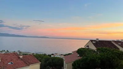 a view of the ocean from the roofs of houses at Le petit paradis avec vue mer in Ajaccio