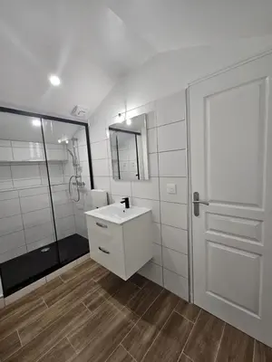 a white bathroom with a sink and a shower at Maison Fernand & Marie Claire in Coti-Chiavari