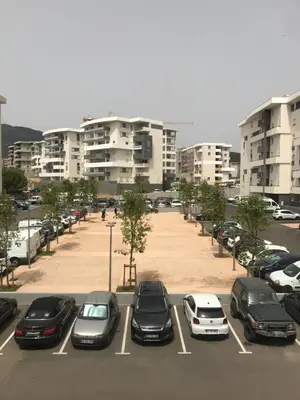 a parking lot with parked cars in a city at Ajaccio j1 in Ajaccio