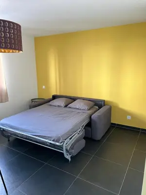 a large bed in a room with yellow walls at Ajaccio j1 in Ajaccio