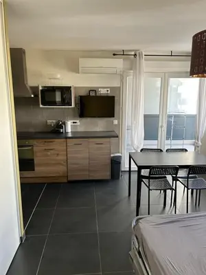 a kitchen and dining room with a table and chairs at Ajaccio j1 in Ajaccio