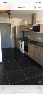 a kitchen with a stove and a microwave at Ajaccio j1 in Ajaccio