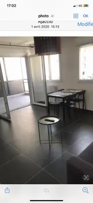 a room with two tables and a table and chairs at Ajaccio j1 in Ajaccio
