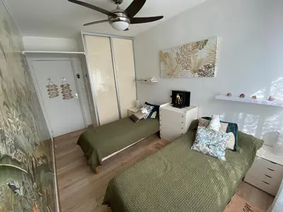 a room with two beds and a ceiling fan at Le Cosy Corse in Vico