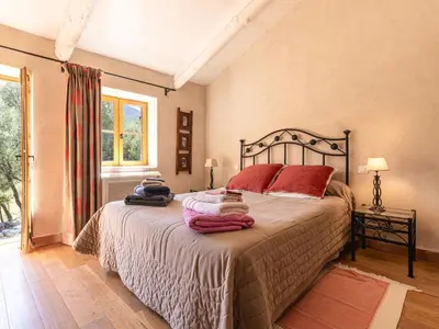 a bedroom with a bed with red pillows on it at Holiday Home Casa Gabrielle by Interhome in Lama