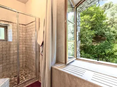 a bathroom with a shower and a window at Holiday Home Casa Gabrielle by Interhome in Lama