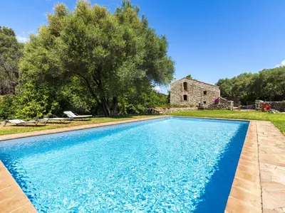 a blue swimming pool in front of a house at Holiday Home Casa Gabrielle by Interhome in Lama
