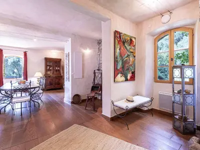 a living room with a table and chairs and a painting at Holiday Home Casa Gabrielle by Interhome in Lama