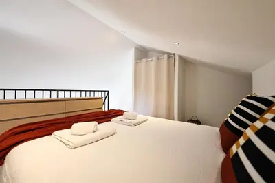 a bedroom with a large white bed with towels on it at Casa di Lilla - Escapade dans une maison de charme in San-Gavino-di-Carbini
