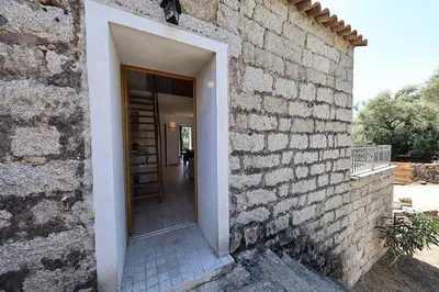an entrance to a building with a brick wall at Casa di Lilla - Escapade dans une maison de charme in San-Gavino-di-Carbini