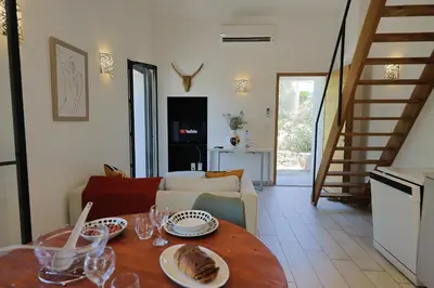 a living room with a table with plates of food on it at Casa di Lilla - Escapade dans une maison de charme in San-Gavino-di-Carbini