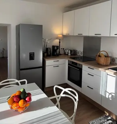 a kitchen with a bowl of fruit on a table at La demeure des vignes in Murato