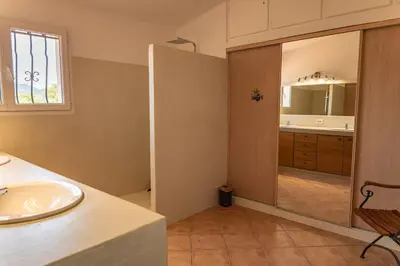 a house with a balcony with a view of a bedroom at Villa Vista Di Pinarello in Pinarellu