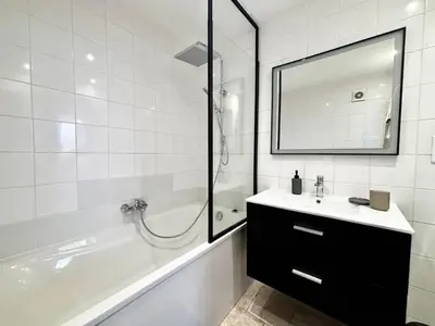a bathroom with a sink and a tub and a mirror at Casamea - Vieille Ville, 2 min plage, Clim in Ajaccio