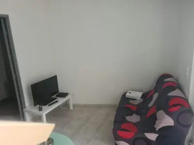 a living room with a couch and a tv at appartement indépendant CORTE in Corte