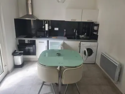 a small kitchen with a table and a sink at appartement indépendant CORTE in Corte