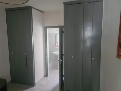 a bathroom with two green cabinets and a sink at appartement indépendant CORTE in Corte