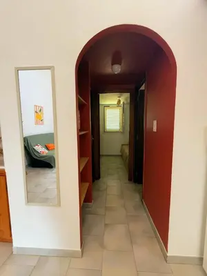 a hallway with an archway leading into a room at La Dolce Villa avec Piscine in Zonza