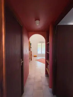 a hallway with an open door and an archway at La Dolce Villa avec Piscine in Zonza