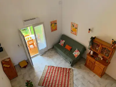 an overhead view of a living room with a green couch at La Dolce Villa avec Piscine in Zonza