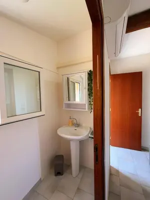 a bathroom with a sink and a mirror at La Dolce Villa avec Piscine in Zonza