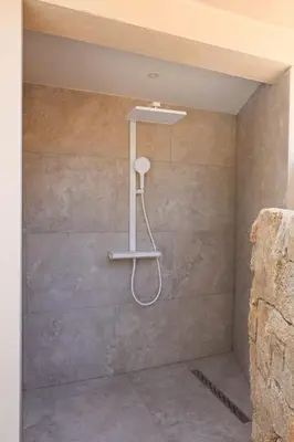 a shower with a shower head in a bathroom at Villa Luciana Di Santa Lucia in Sainte-Lucie de Porto-Vecchio