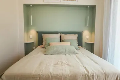 a large bed in a bedroom with two tables at Villa Luciana Di Santa Lucia in Sainte-Lucie de Porto-Vecchio
