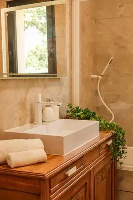 a bathroom with a white sink and a mirror at Villa Luciana Di Santa Lucia in Sainte-Lucie de Porto-Vecchio