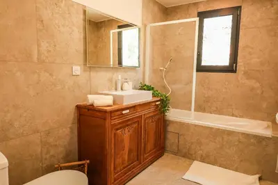 a bathroom with a sink and a toilet and a tub at Villa Luciana Di Santa Lucia in Sainte-Lucie de Porto-Vecchio