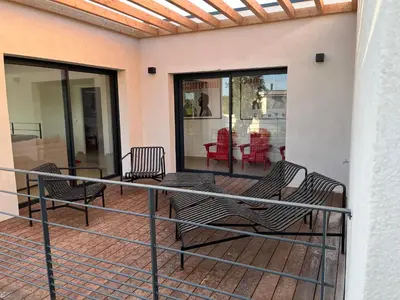 a balcony with a table and chairs on it at A Cupulata in Porto-Vecchio