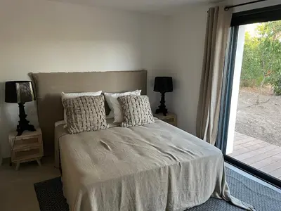 a bedroom with a bed with pillows and a window at A Cupulata in Porto-Vecchio