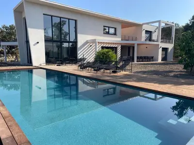 a house with a swimming pool in front of it at A Cupulata in Porto-Vecchio
