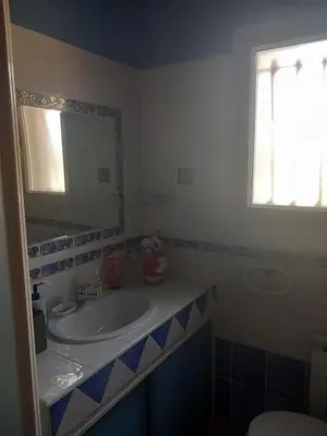 a bathroom with a sink and a mirror at Chez Rachel chambre et salle bain privative chez l'habitant in Aléria