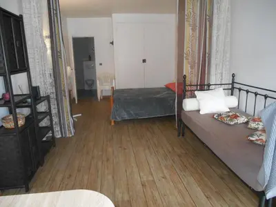 a bedroom with a bed and a wooden floor at B&B la rivière in Penta-di-Casinca