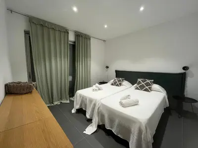a bedroom with two beds with white sheets at Haut standing- Face à la mer! 3 chambres-piscine semi olympique in Sari Solenzara