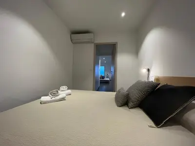 a bedroom with a large bed with at Haut standing- Face à la mer! 3 chambres-piscine semi olympique in Sari Solenzara