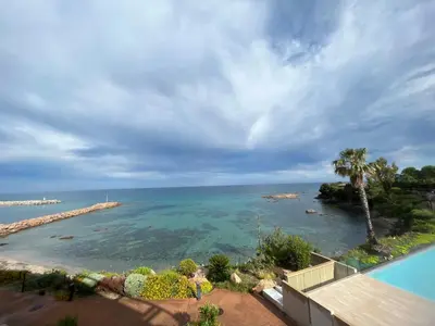 a view of the ocean from a resort at Haut standing- Face à la mer! 3 chambres-piscine semi olympique in Sari Solenzara
