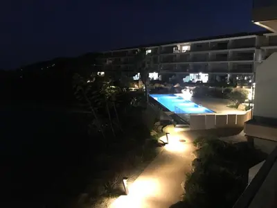 a view of a swimming pool at night at Haut standing- Face à la mer! 3 chambres-piscine semi olympique in Sari Solenzara