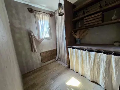 a room with a window and a curtain on the wall at U Loghju in Oletta