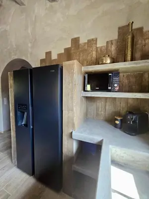 a kitchen with a stainless steel refrigerator and a counter at U Loghju in Oletta