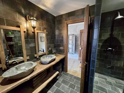 a bathroom with two sinks and a shower at U Loghju in Oletta