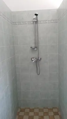 a shower stall with a hose in a bathroom at Maisonnette 2 minutes pied plage in Grosseto-Prugna